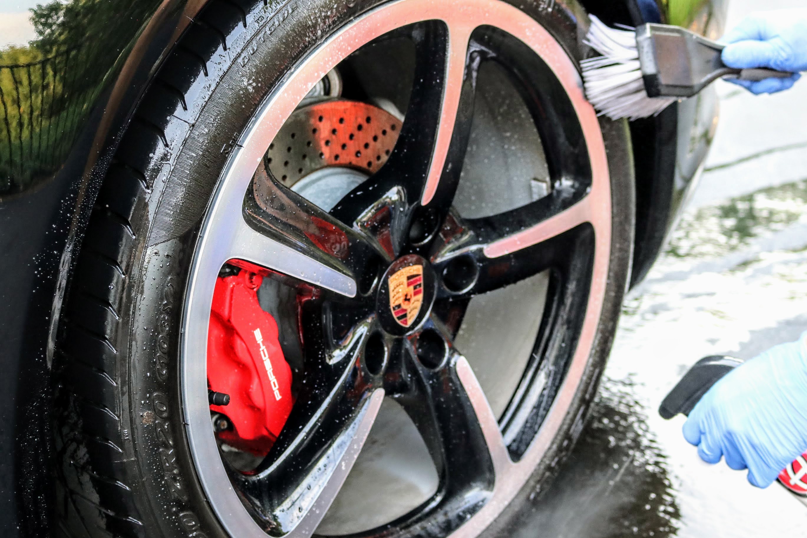 Using a tire brush and Adam's Polishes Tire and Rubber Cleaner to clean Porsche 911 (991.1) tires